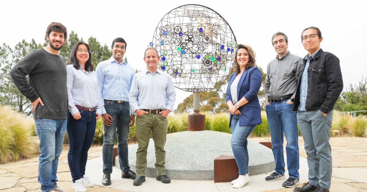  From the left, Jorge Baño-Medina, Zhiqi Yang, Agniv Sengupta, Luca Delle Monache, Vesta Afzali Gorooh, Mohammadvaghef Ghazvinian and Weiming Hu, members of the Machine Learning Team at the Center for Western Weather and Water Extremes, gather around a sculpture entitled "Atmospheric Rivers," created by artist Oscar Romo, outside Nierenberg Hall at Scripps Institution of Oceanography. The team is using AI to improve the prediction of atmospheric rivers, which are expected to intensify as the climate continu